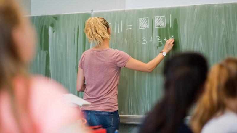 Was muss man für den Quereinstieg als Lehrer mitbringen? Lehrerin an der Tafel