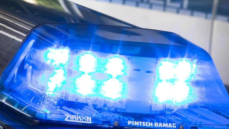 Mann zeigt vorbeifahrenden Polizisten Hitlergruß Blaulicht