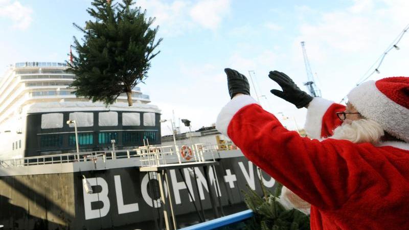 Tannenbaumweitwurf über die Reling: Bescherung für Seeleute Weihnachtsmann bringt Tannenbäume für Seeleute an Bord