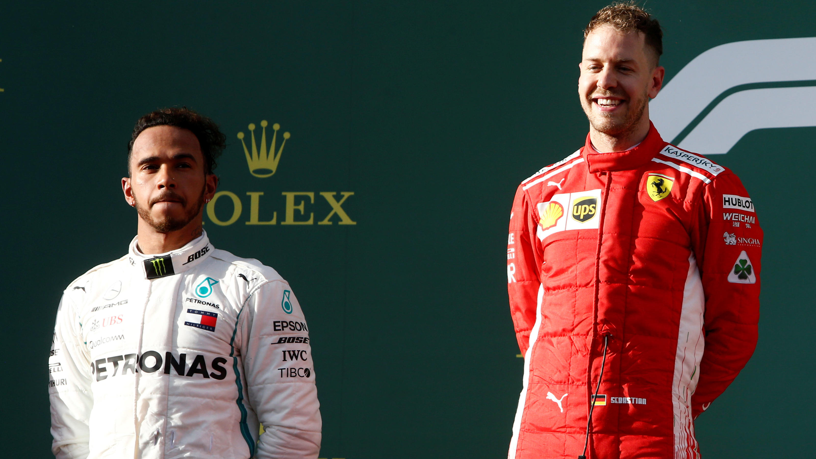 Ferrari's Sebastian Vettel celebrates his win on the podium with Mercedes' Lewis Hamilton REUTERS Brandon Malone
