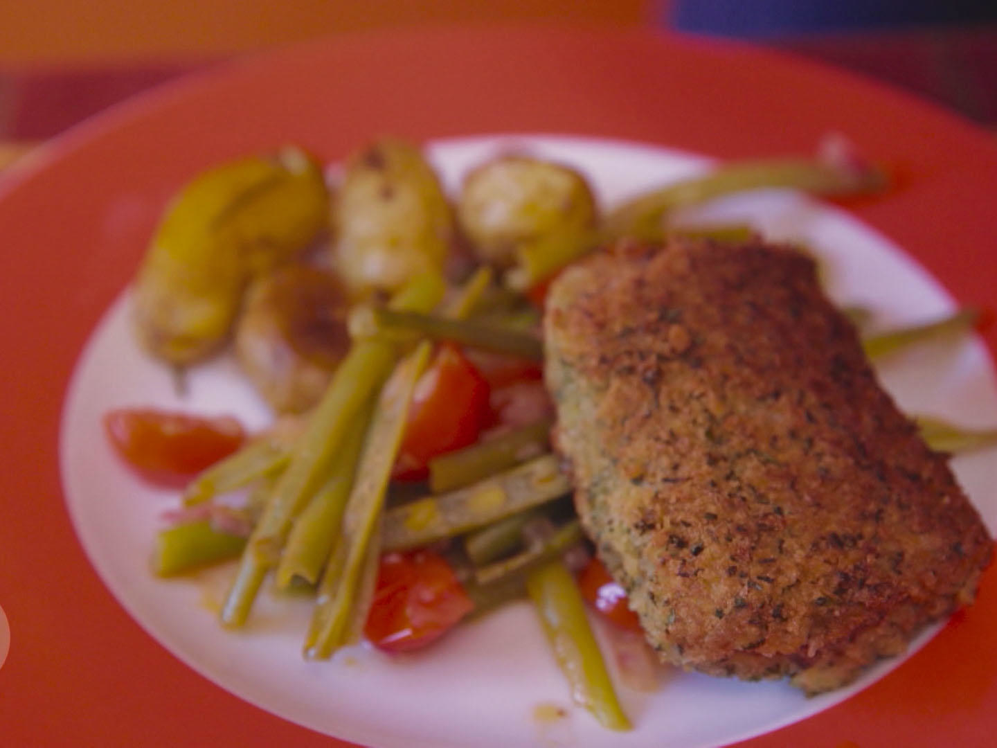 Kräuterschnitzel von Lammlachsen auf buntem Bohnensalat mit Papas Arrugadas